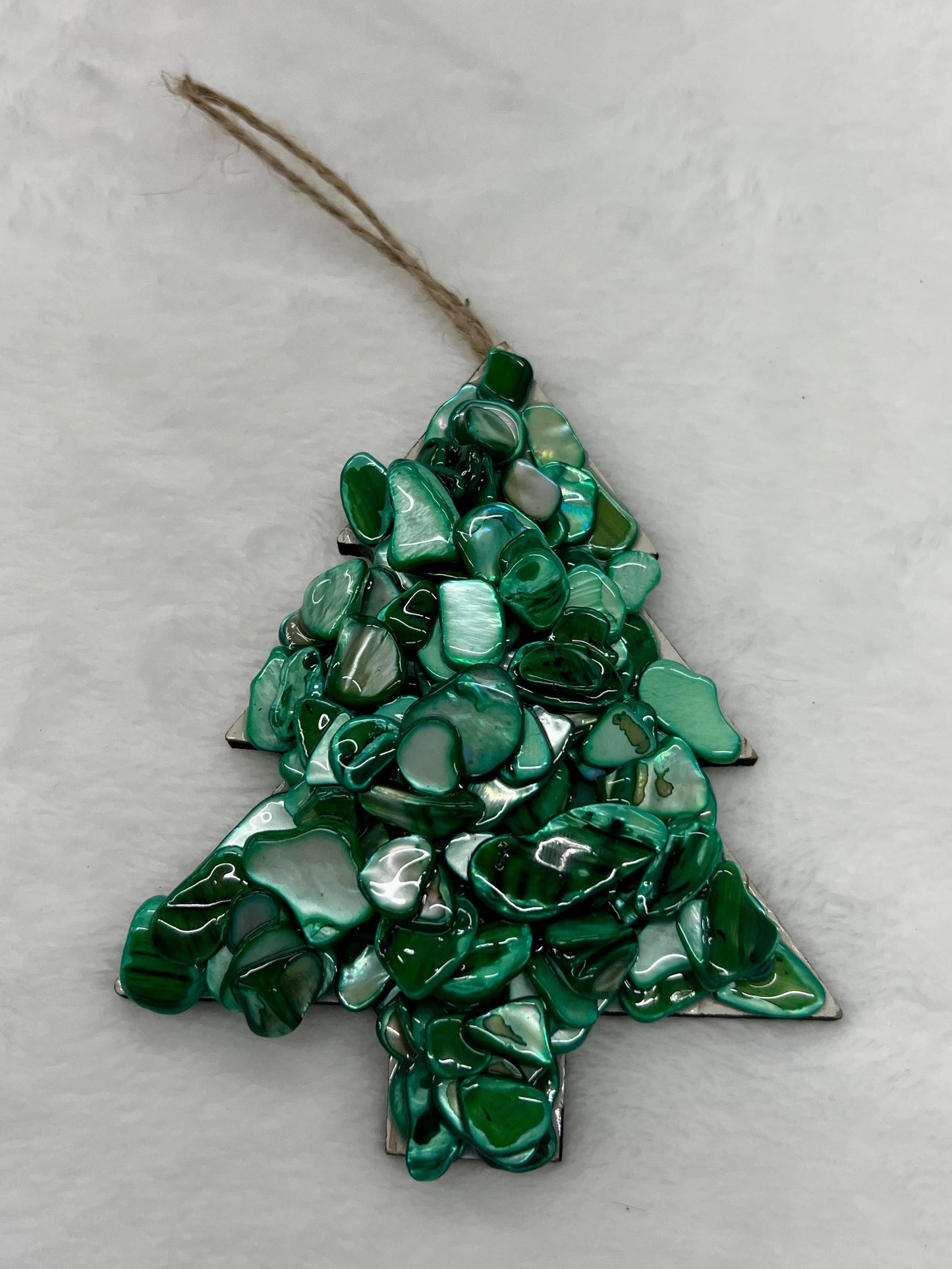 Green tree-shaped ornament on a white background