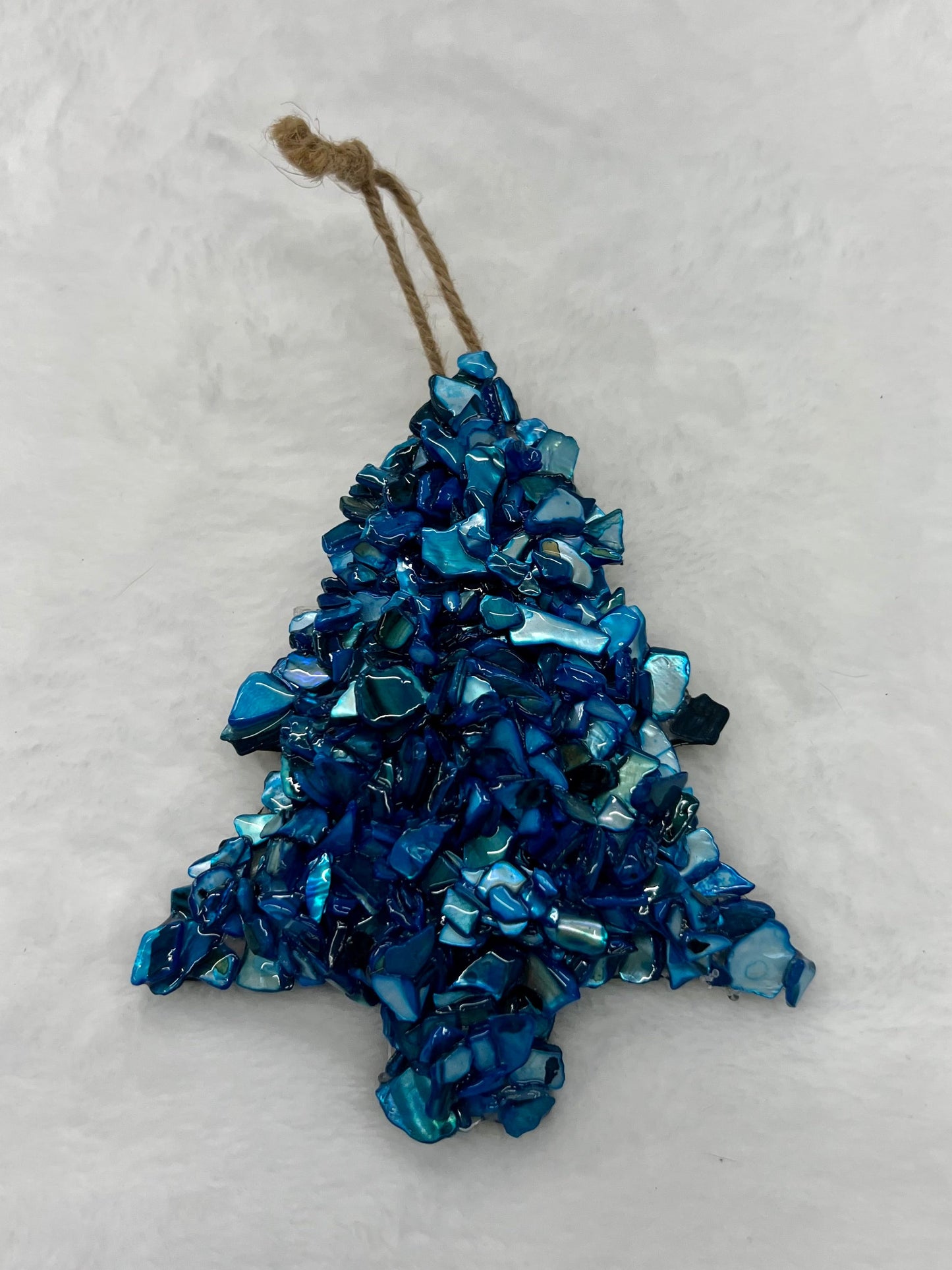 Blue decorative tree ornament on a white background