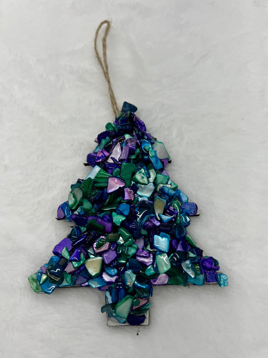 Decorative Christmas tree ornament with blue and green mosaic pattern on a white background